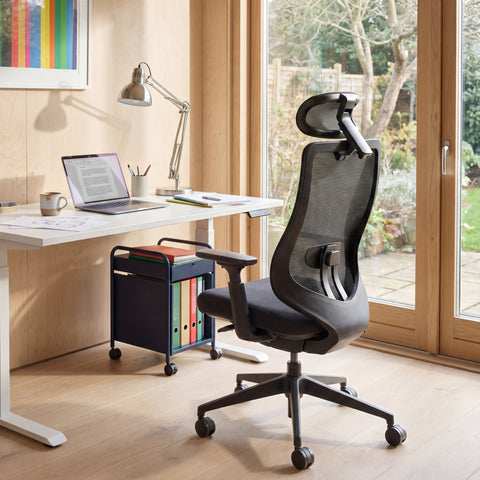 Rear View of COLAMY ATLAS-01 Black Executive Mesh Ergonomic Office Chair in a Bright Home Office with a Standing Desk