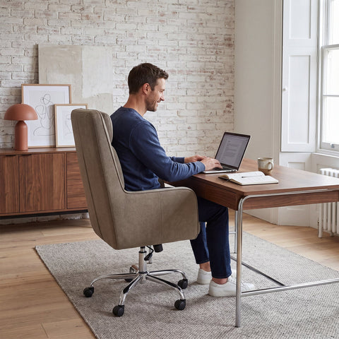 Man working on a laptop while seated in the COLAMY COCOON Taupe High-Load Cloud Comfort Swivel Office Chair at a home office desk